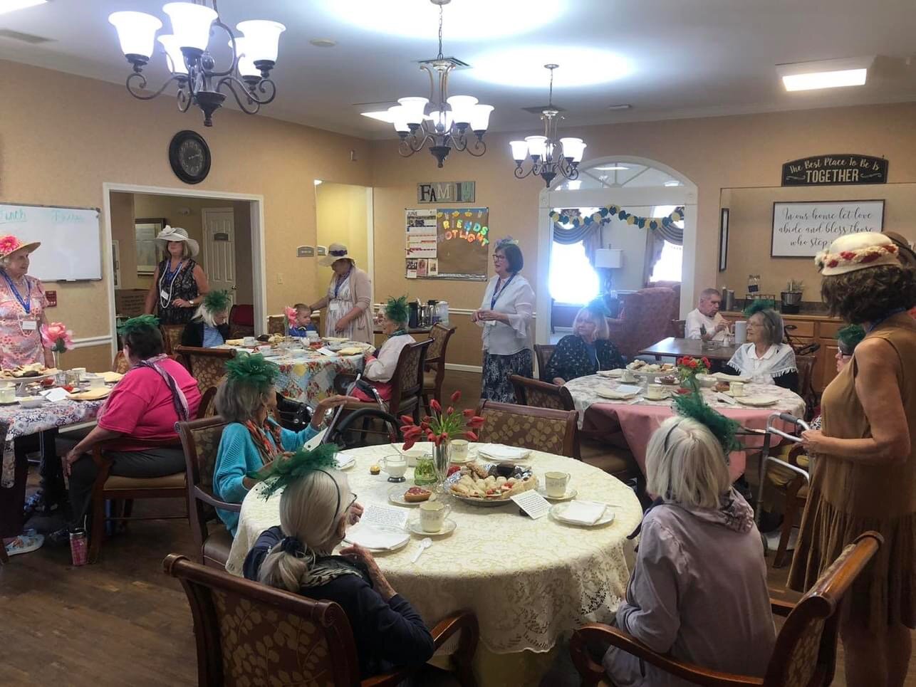 St. Martin Women’s Ministry group members and Westbrook Terrace residents gather around the daintily set tables in the community dining room.